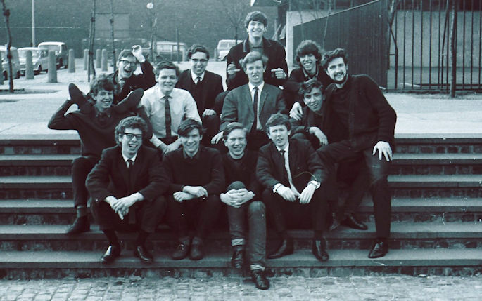 Black and white photo from 1960's showing a group of students sat outside 